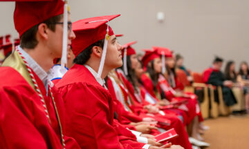 graduates in red caps and gowns