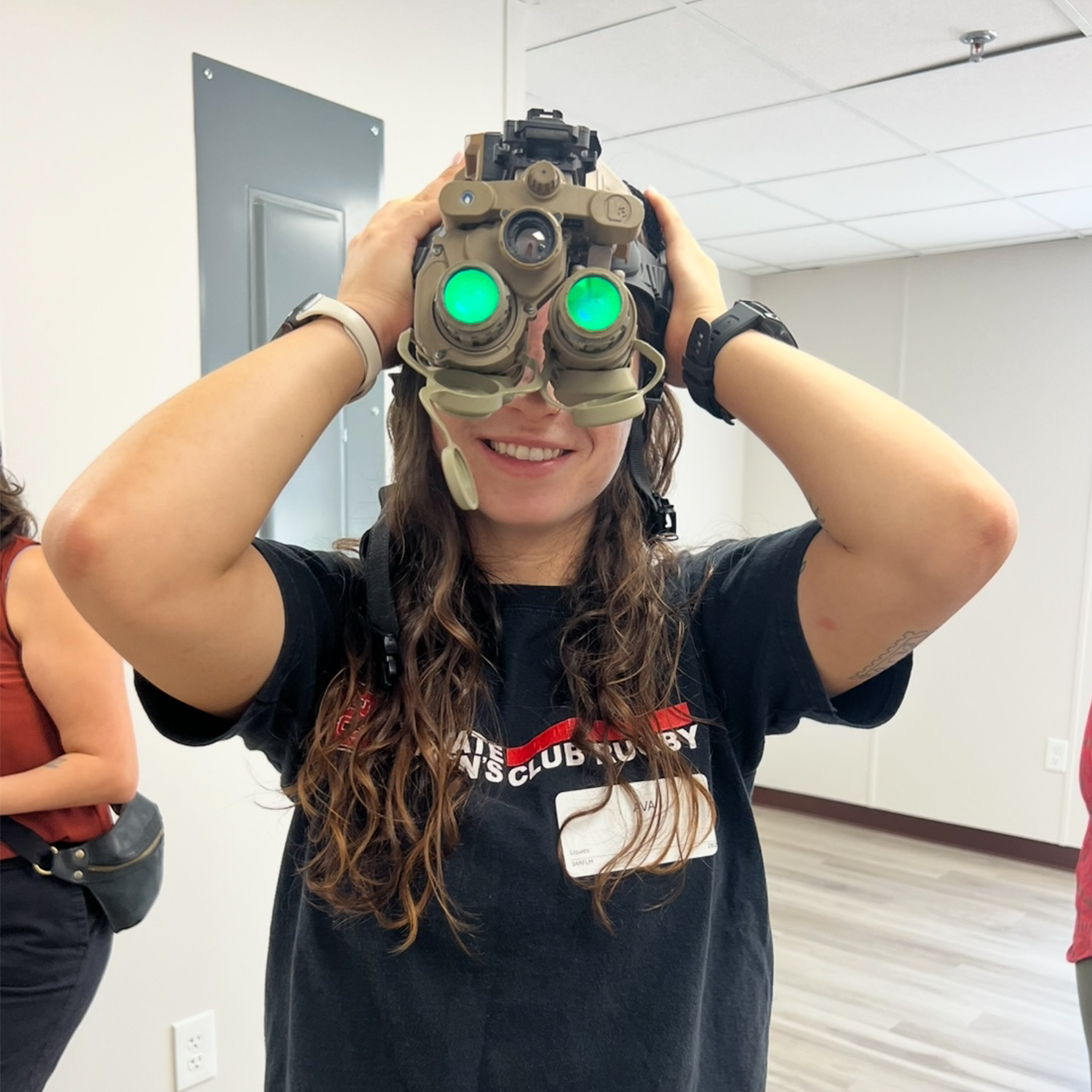 brunette college aged female testing binoculars at a lab