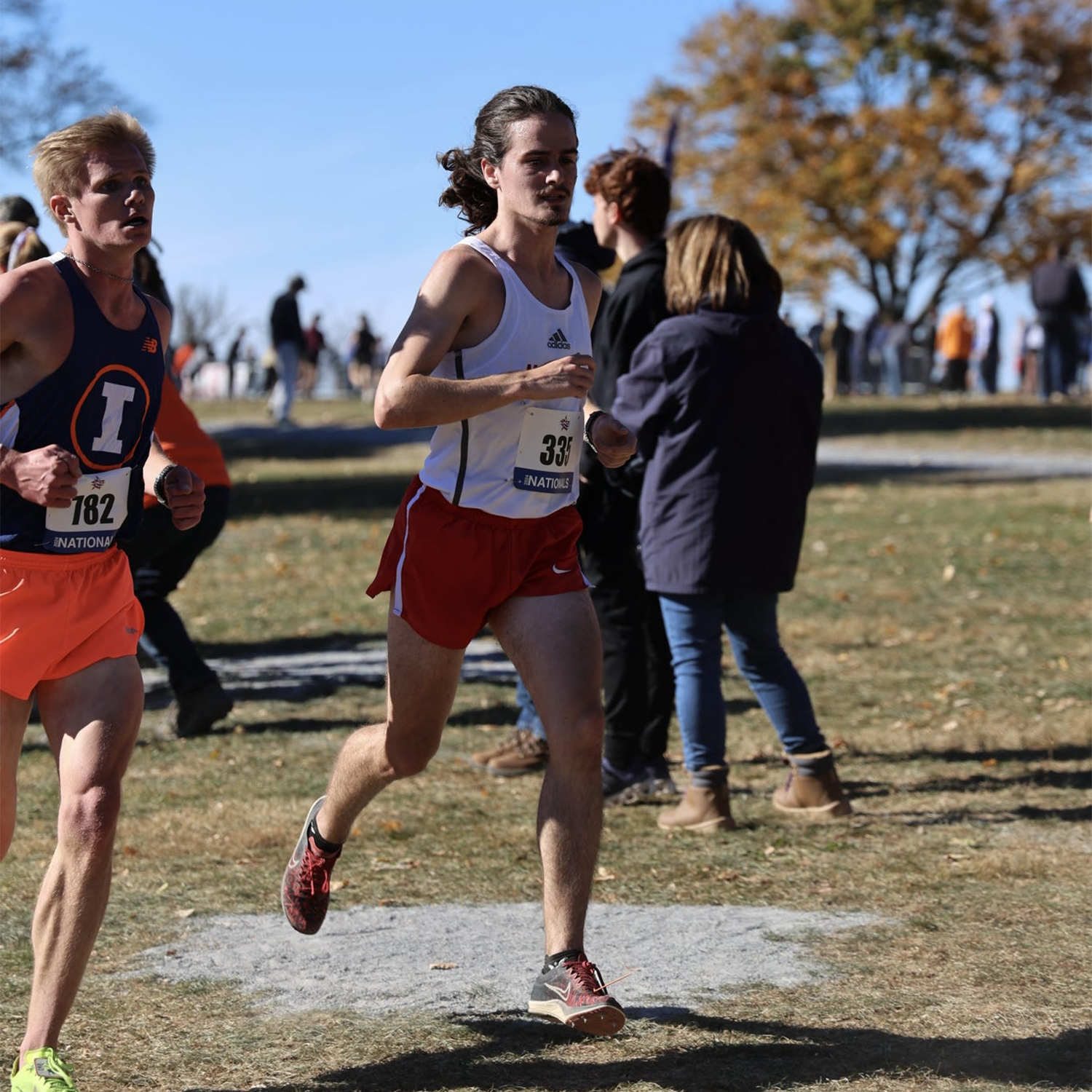male college student running in a cross country race